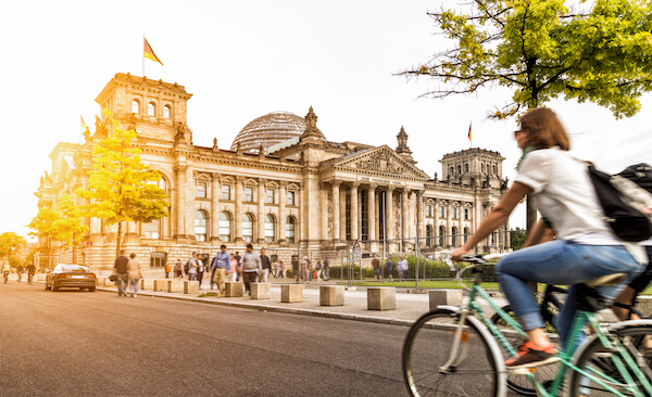 Germany Reichstag in Berlin with flag and cyclist