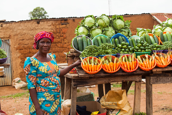 Nigerian farmer selling fruits and vegetables on the market