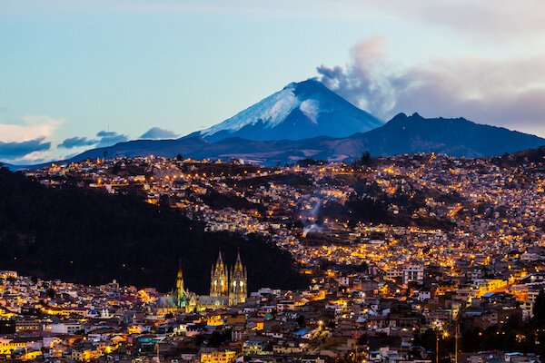 Quito, capital city of Ecuador with fuming Cotopaxi volcano in the background