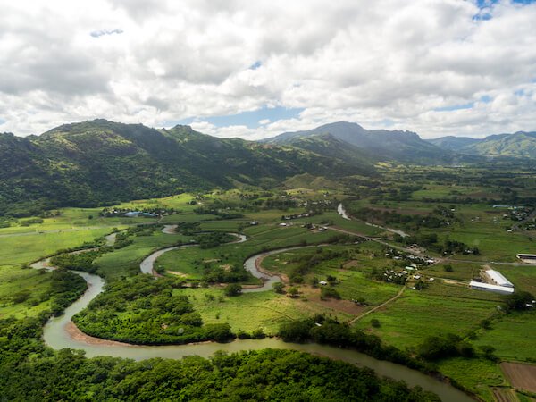aerial of Viti Levu island with lush green landscape, mountains and river
