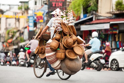 Street vendor on bike in Hanoi's Old Quarter - image by Tony Duy/Shutterstock.com