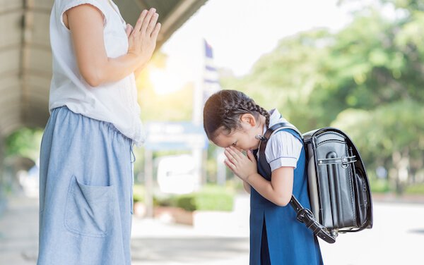Thai child greeting the mother before going to school