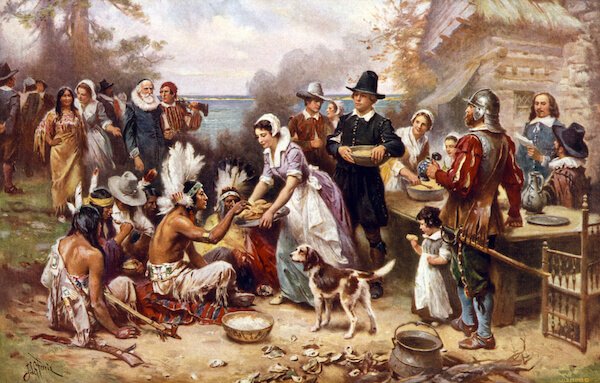 The first Thanksgiving, 1621, Pilgrims and natives gather to share a meal, oil painting by Jean Louis Gerome Ferris, 1932. - image by Everett Historical/shutterstock.com